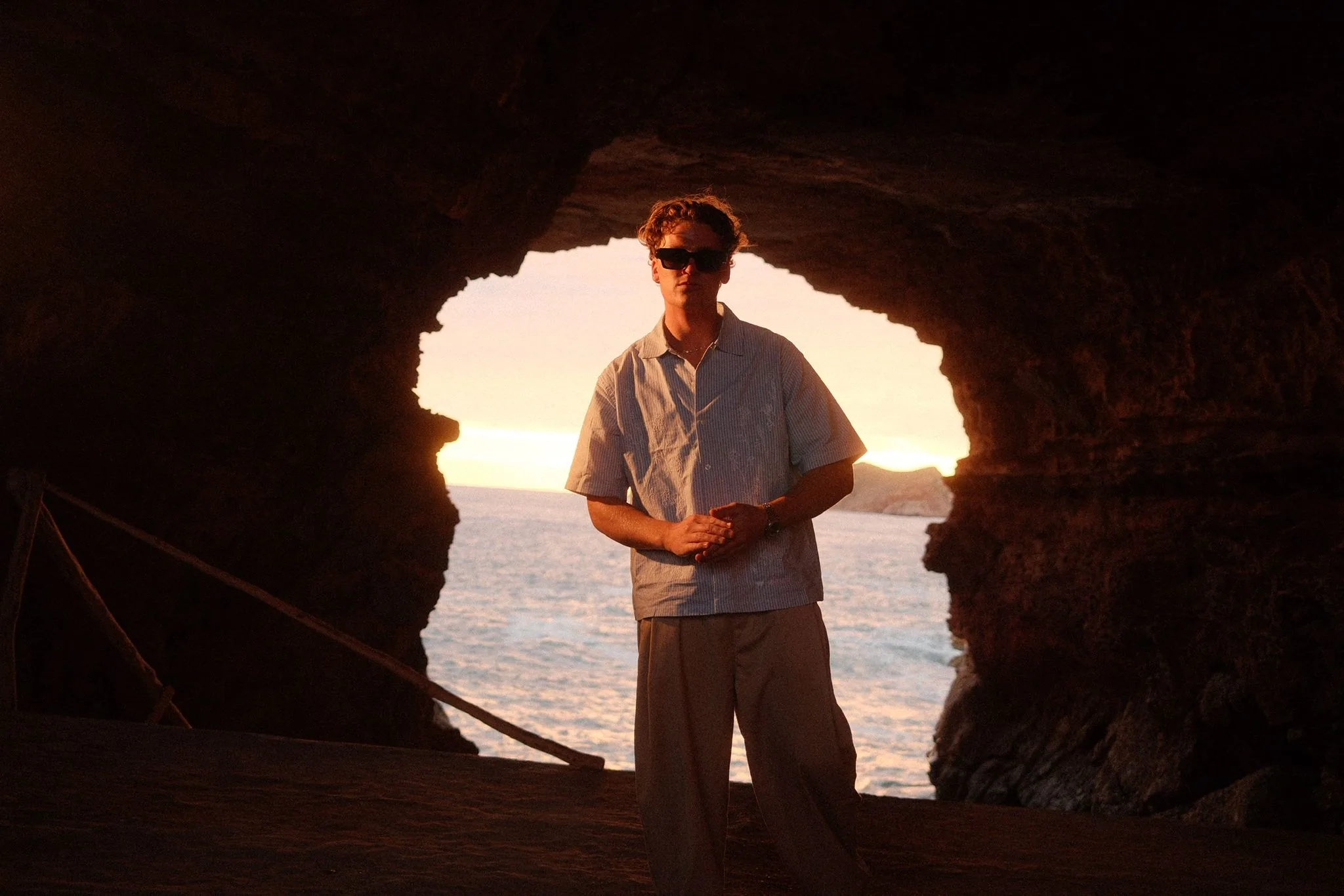 Carston at sunset, framed by a sea cave